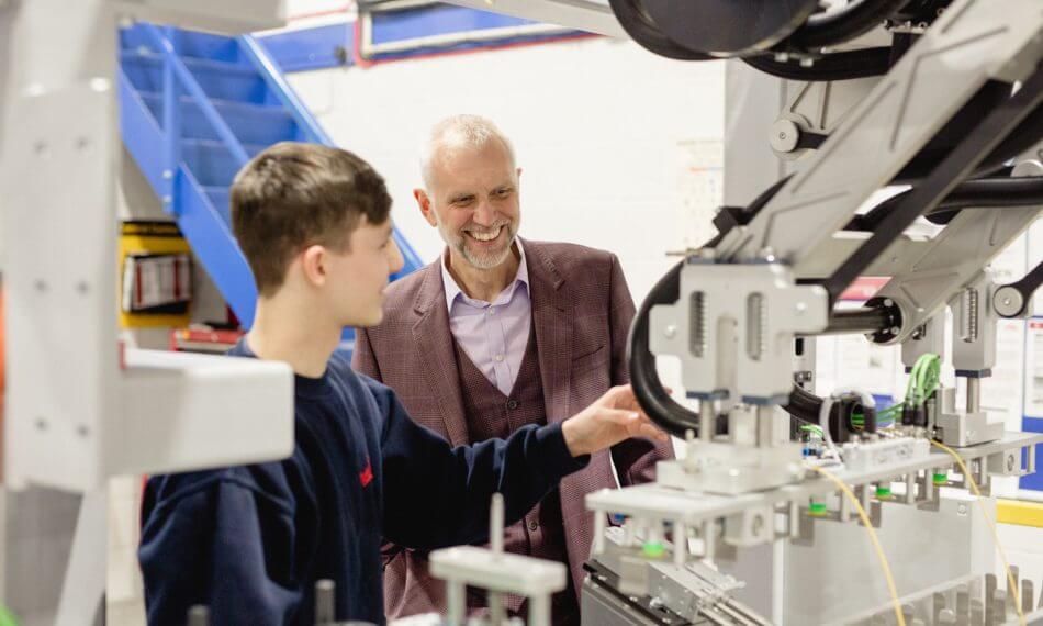 Two males inspecting machinery