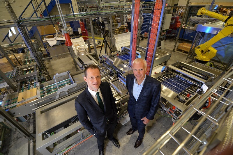 Two males standing amongst machinery