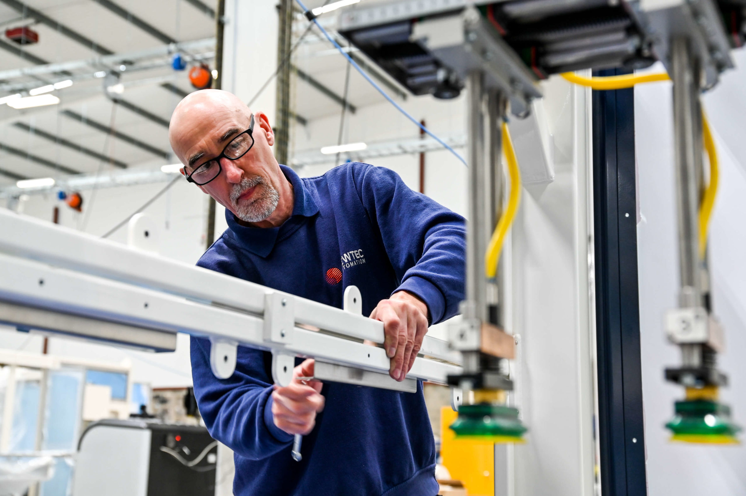 Employee installing an automated machine